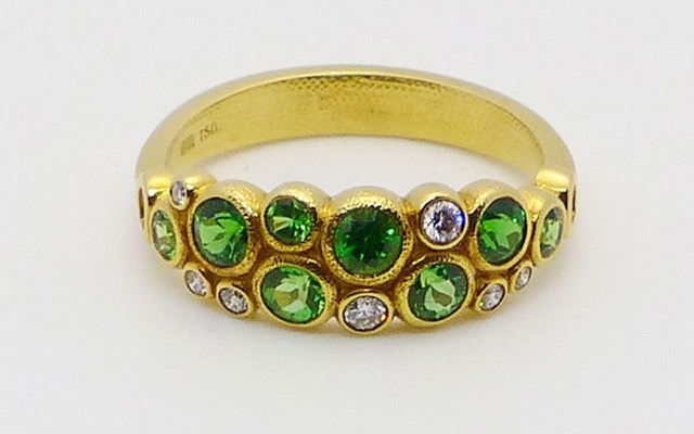R-113S
Tsavorite & diamond ring, 18K yellow gold, 8 tsavorite garnets totaling 1.0 ct and 7 diamonds totaling 0.12 ct. 
Available for immediate delivery in finger size 7.
$3,855
