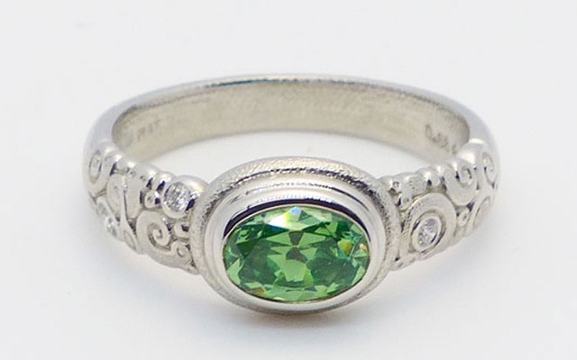 R-82P
Platinum garnet ring, 0.88 ct demantoid garnet, 3 side diamonds totaling 0.05 ct. 
Available for immediate delivery in finger size 6
$6,500.00
