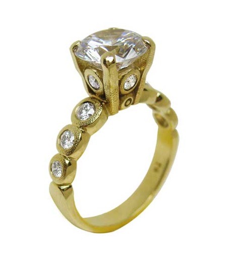 R-193MD 
“Candy” Ring Mounting, 18K yellow gold, Cubic Zirconia center stone (center fits a 8.5-9.5mm  round stone), 10 accent diamonds totaling 0.42ct. 
Available for immediate delivery in size 5 ¾. 
$4,180.00 (Note center stone is not a diamond!)
