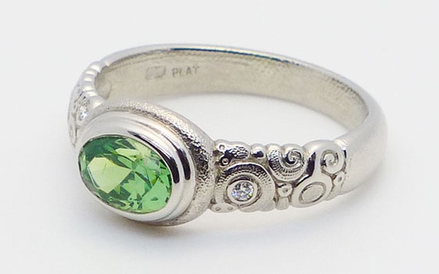 R-82P
Platinum garnet ring, 0.88 ct demantoid garnet, 3 side diamonds totaling 0.05 ct. 
$6,500
Available for immediate delivery in finger size 6

