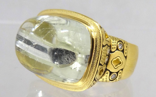 R-103 
“Garden” ring in 18K yellow gold with a unique aquamarine cabochon with a tourmaline inclusion, 12 diamonds totaling 0.20 ct.
Available for immediate delivery in finger size 6 ¼. 
$5,430
