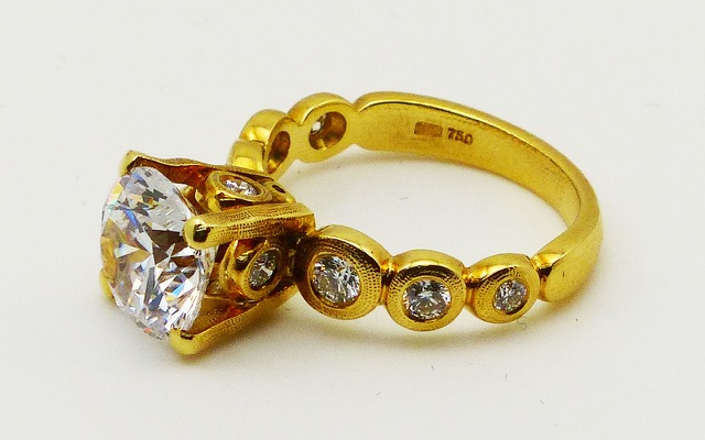 R-193MD 
“Candy” Ring Mounting, 18K yellow gold, Cubic Zirconia center stone (center fits a 8.5-9.5mm  round stone), 10 accent diamonds totaling 0.42ct. 
Available for immediate delivery in size 5 ¾. 
$4,180 
