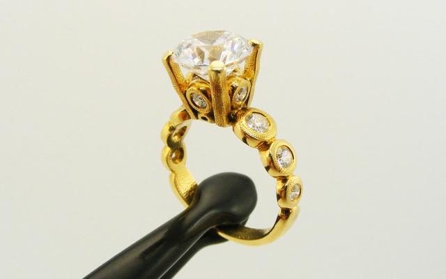 R-193MD 
“Candy” Ring Mounting, 18K yellow gold, Cubic Zirconia center stone (center fits a 8.5-9.5mm  round stone), 10 accent diamonds totaling 0.42ct. 
Available for immediate delivery in size 5 ¾. 
$4,180 

