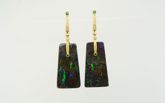 E167
“Sticks & Stones” opal earrings in 18K yellow gold with boulder opal drops and 2 Tsavorite garnets. Veins of brilliant multi-colored opal course through fields of rich brown ironstone matrix in this dramatic pair of matrix boulder opals from Queensland, Australia. The opals total 65.61 cts.
Immediate delivery 
SOLD
