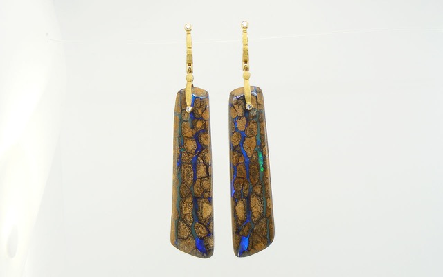 E167MD
“Sticks & Stones” opal earrings in 18K yellow gold with boulder opal and 4 diamonds totaling 0.17 ct. These dramatic Australian matrix boulder opals exhibit rivulets of vivid blue-green and deep blue opal coursing through Klimt-like cells of ironstone matrix. The stones themselves are approximately 2.5 inches long and have a total weight of 98.82 ct.
Immediate delivery
$11,275
