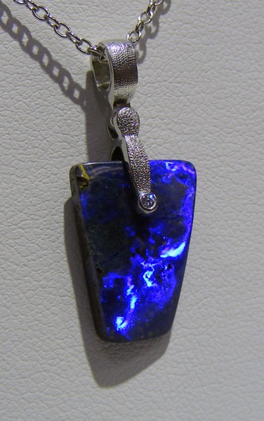 #M-48PD
“Sticks & Stones” pendant in Platinum, featuring a 6.37 ct Australian Boulder Opal, and a .008 ct diamond (F-G/VVS). Opal displays a dark body with a vivid and lively electric blue flash.
$1,010
(Chain not included in price. This item is available in-store at Studio Jewelers.)
