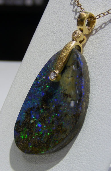 #M-57MD
“Sticks & Stones” in 18K yellow gold, featuring a 23.55 ct Matrix Boulder Opal and .03 ct diamond (F-G/VVS)
$1,762
(Chain not included in price. This item is available in-store.)
