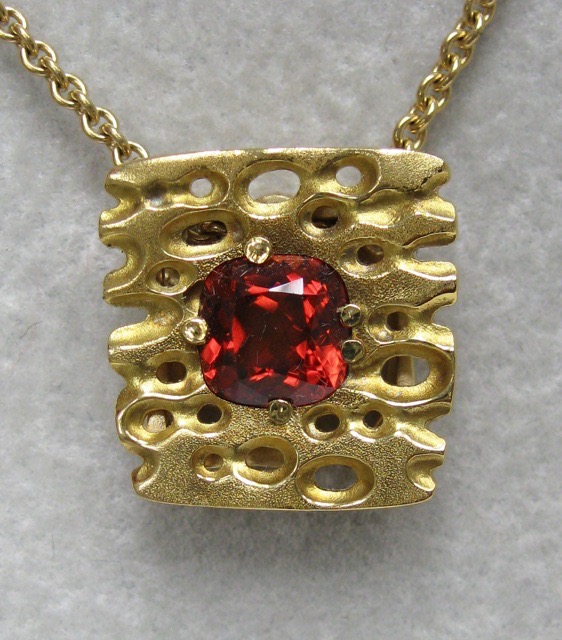 #M-30
“Square Characters” pendant, 18KY, 1.50 ct Mandarin Garnet
(This item has sold, but can be special ordered with a different gemstone.)
