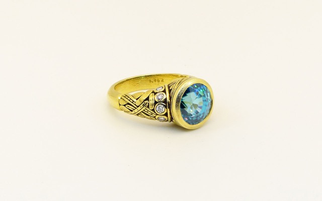 R-58M
“Reed” blue zircon ring, 18K yellow gold, 8.40 ct blue zircon center gemstone, 10 diamonds of  0.28 ct total. 
 $10,315
