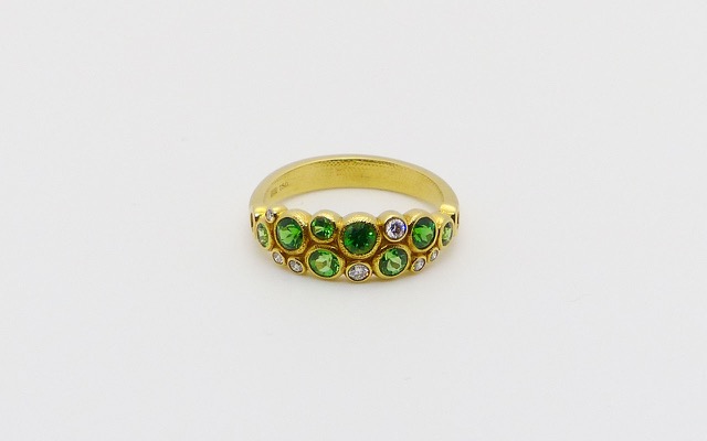 R-113S
Tsavorite & diamond ring, 18K yellow gold, 8 tsavorite garnets totaling 1.0 ct. and 7 diamonds totaling 0.12 ct. 
Available for immediate delivery in finger size 7.
$3,855
