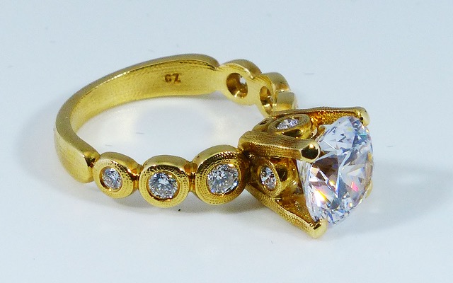 R-193MD 
“Candy” Ring Mounting, 18K yellow gold, Cubic Zirconia center stone (center fits a 8.5-9.5mm  round stone), 10 accent diamonds totaling 0.42ct. Available for immediate delivery in size 5 ¾. 
$4,180 
