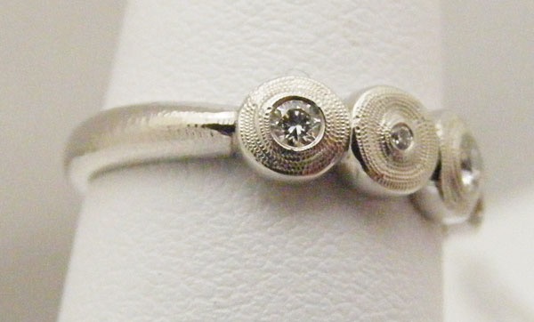 R210PD
“Five Seeds”, Platinum & diamond ring, (5 diamonds = .20 ctw), in store in size 6 ¼
$3,005
